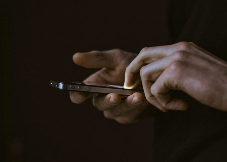 man holding an mobile phone in hands