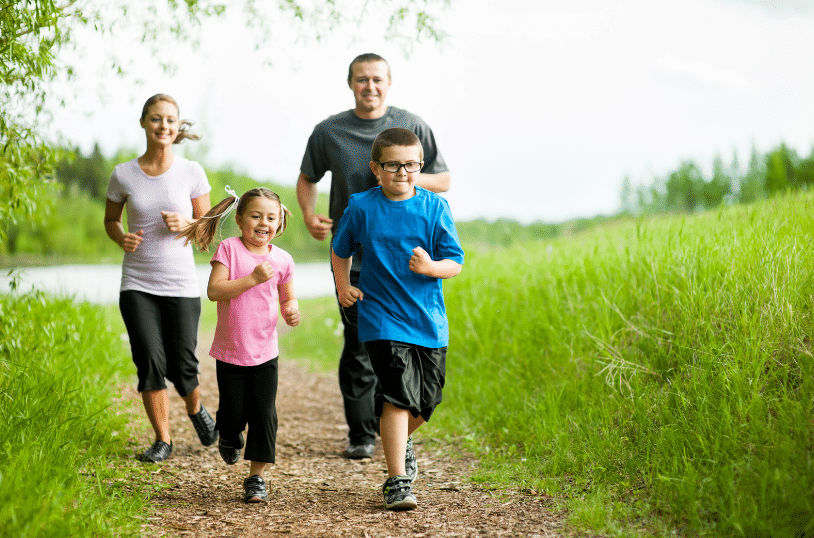 Family running outside on a path