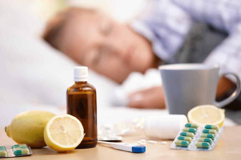 woman sleeping next cold medicine