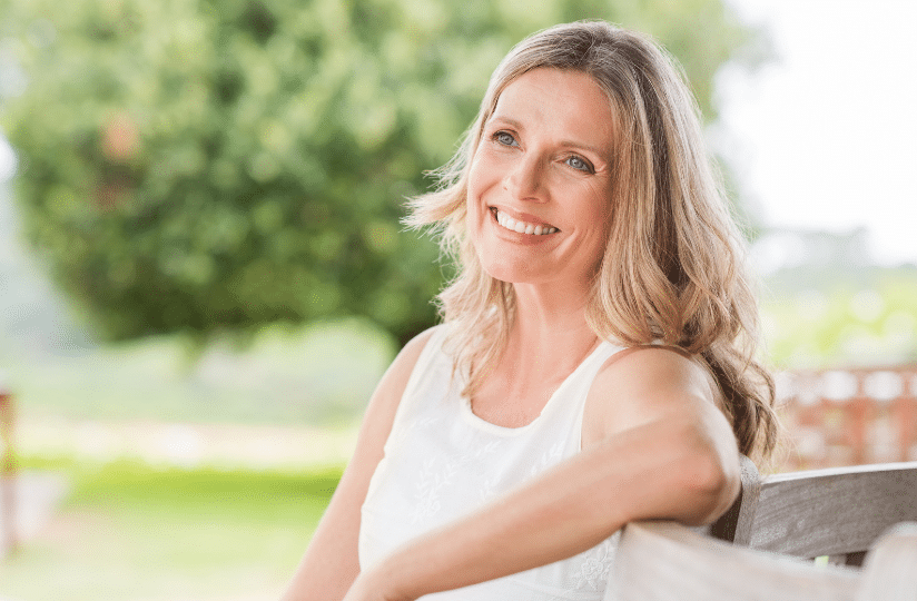 woman smiling sitting outside