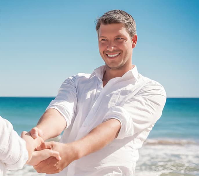 man smiling at the beach