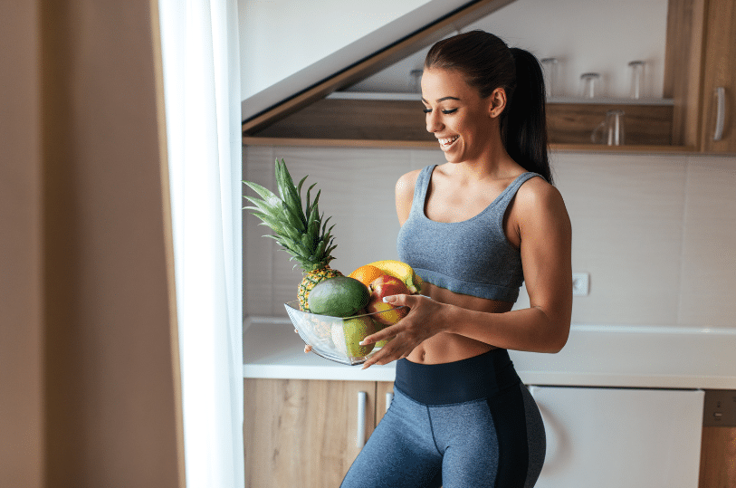 woman carrying a basket of fruit