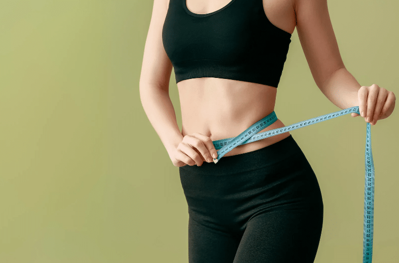 woman measuring her waist line