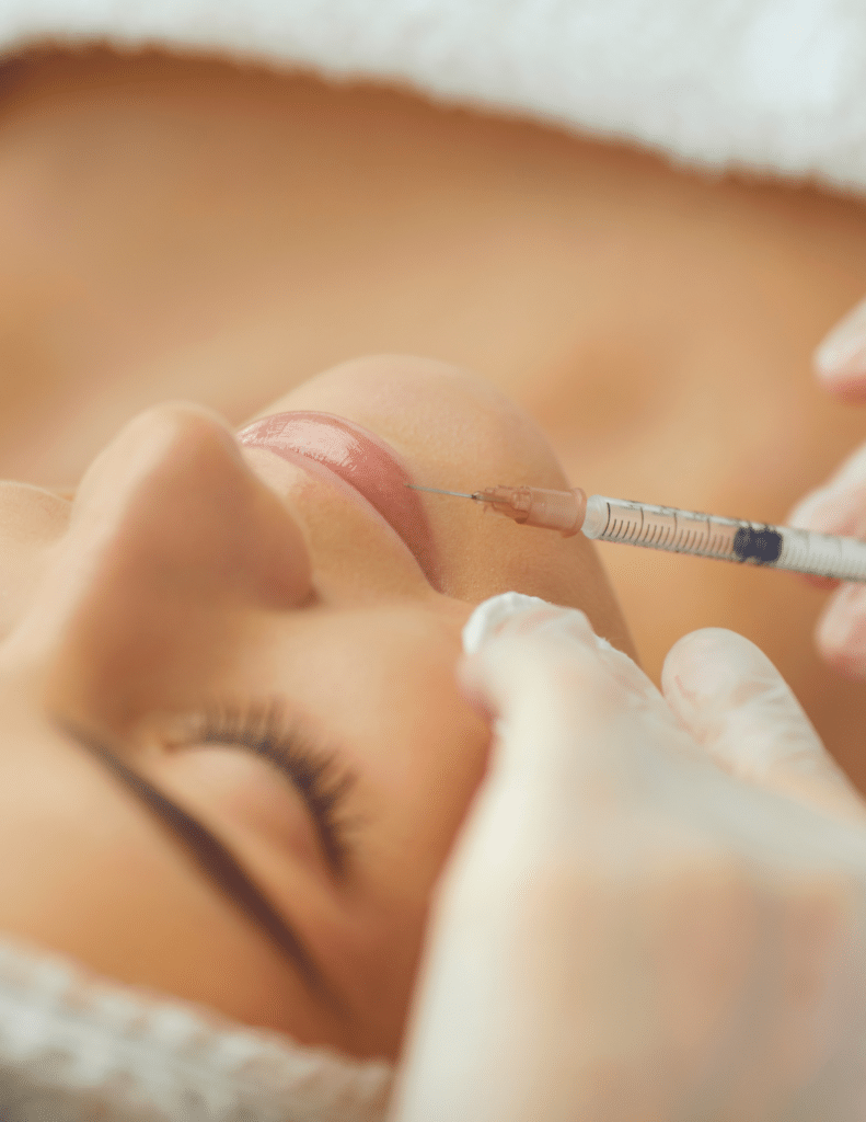 Woman receiving natural lip injections at Formula Wellness to enhance volume and shape with subtle, balanced results.
